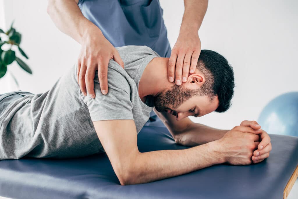 Chiropractor massaging shoulder and neck of man on Massage Table in hospital
Shoulder injuries